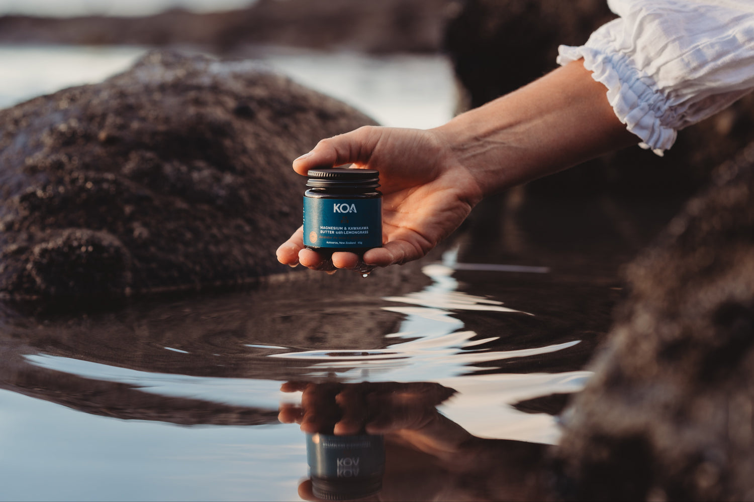 Koa Magnesium Butter in hand lifted out of water