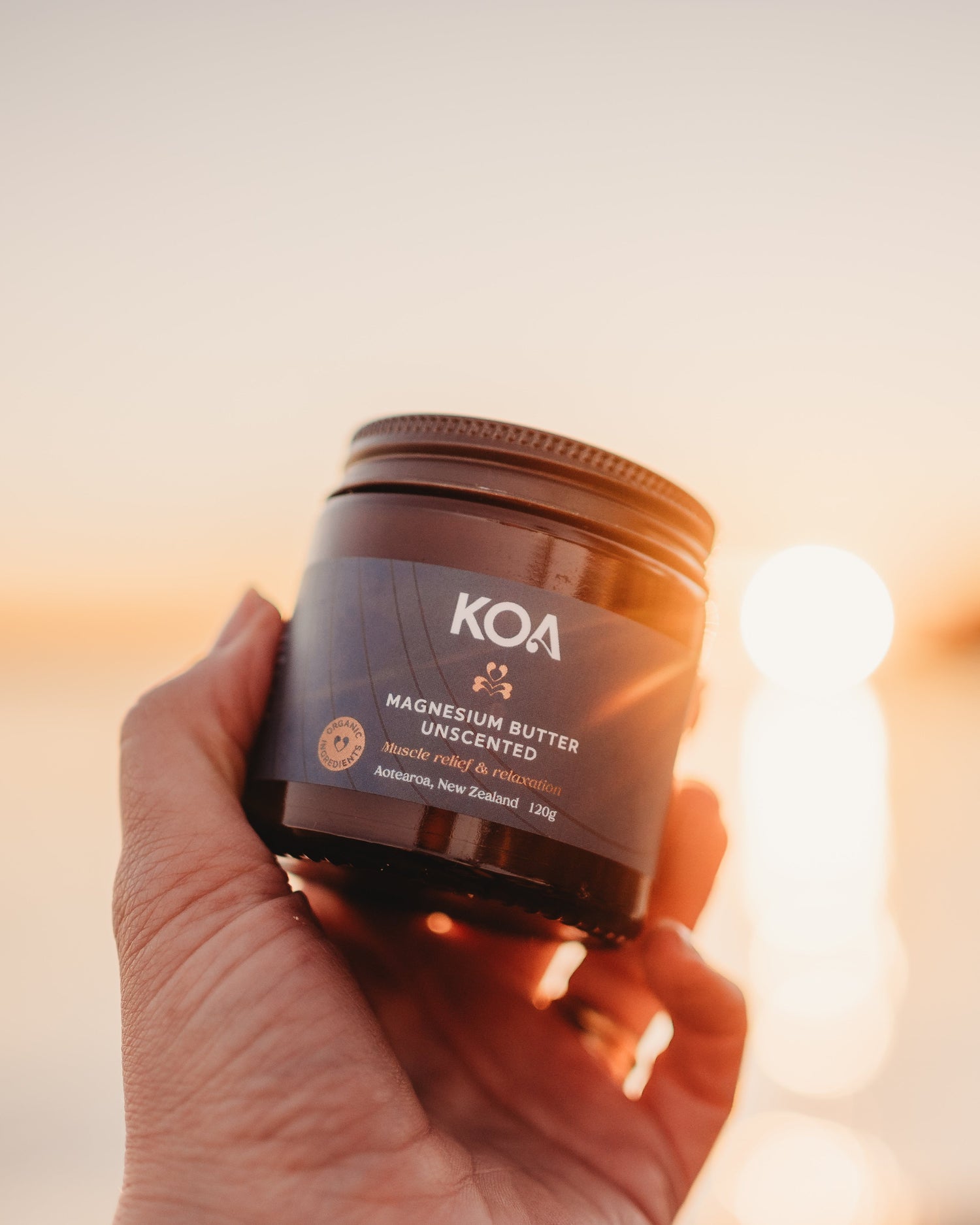 Magnesium Butter Unscented in hand with glowing sunlight